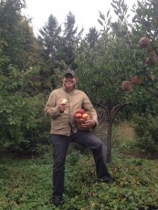 Dr. Bashioum picking apples from his Wayzata garden